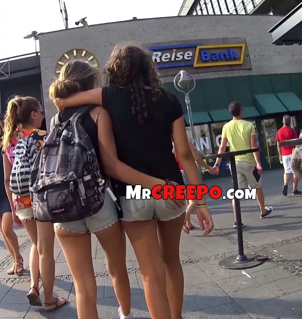 Teen girl hugs friend and rubs her ass on the street